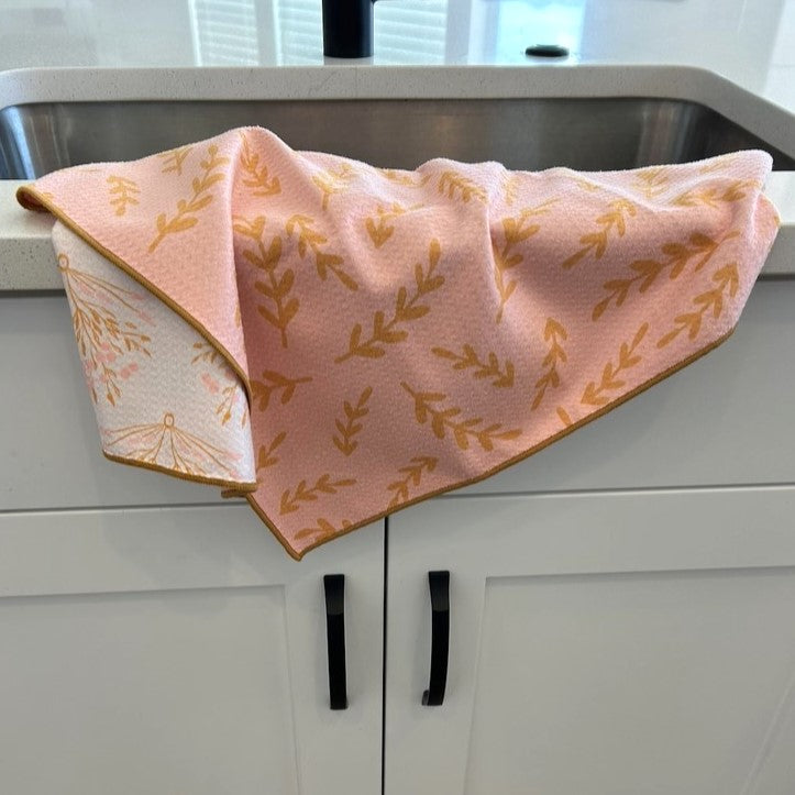 Autumn-themed kitchen towel folded on countertop