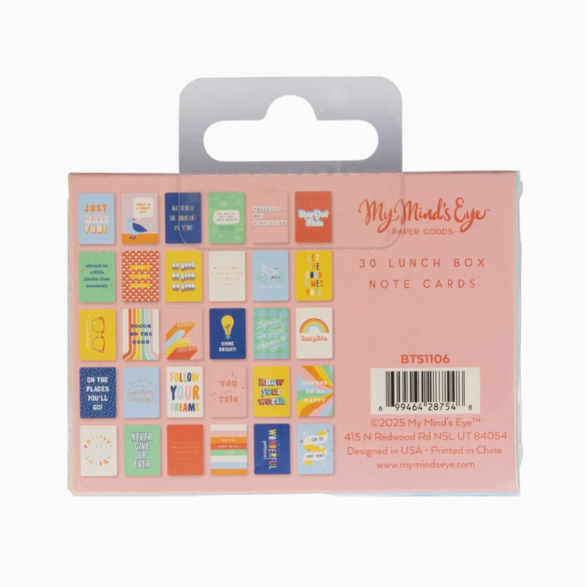 Packaging of 3D lunch box note cards with colorful designs on a pink background.