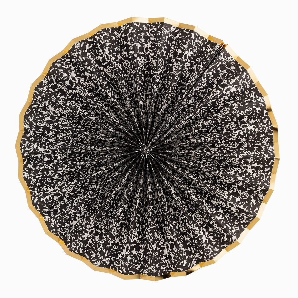 Black and white patterned umbrella with wooden handle on a white background