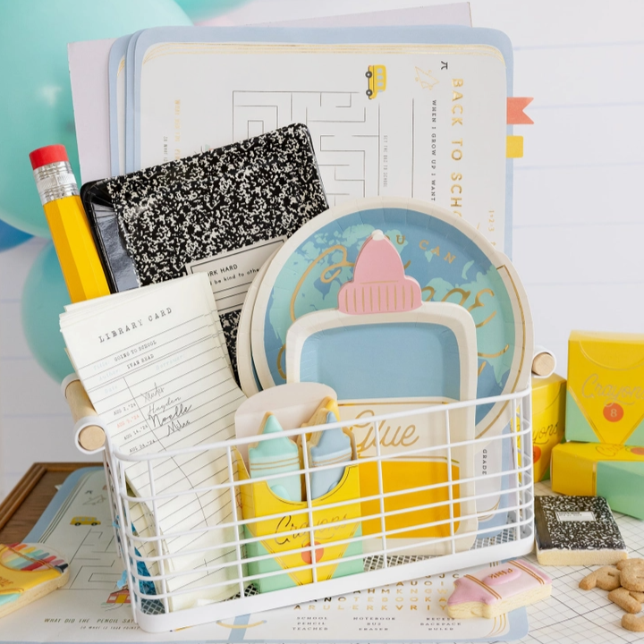 Desk organizer with stationery items including a pencil, notebook, and glue stick on a desk.