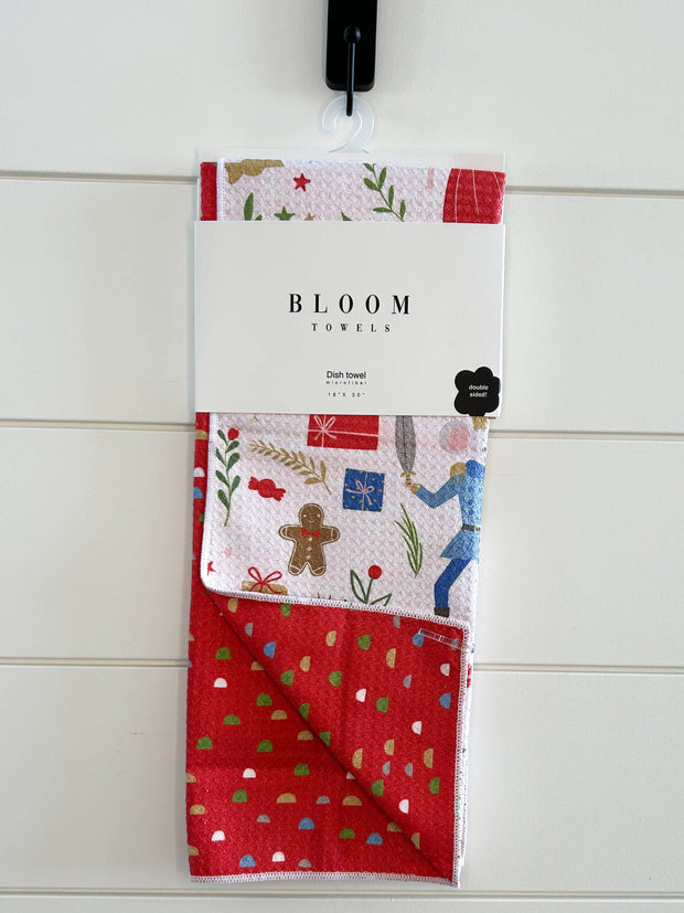 Packaged towel with festive Nutcracker design on a white wooden background