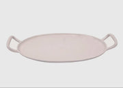 A white ceramic serving tray with handles, displayed against a plain background.