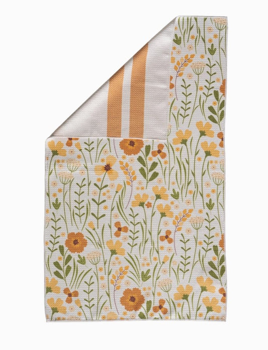 Floral patterned fabric with yellow flowers and green leaves on a white background