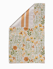 Floral patterned fabric with yellow flowers and green leaves on a white background