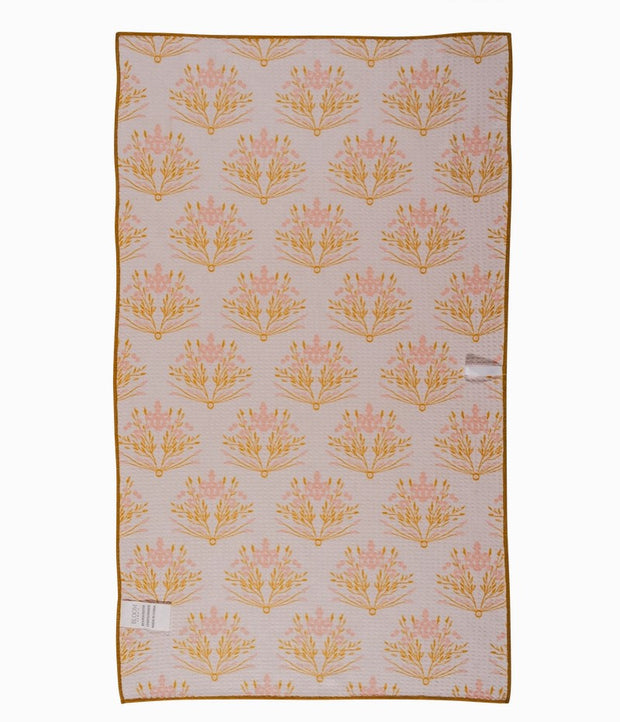 Golden floral tea towel on farmhouse kitchen counter