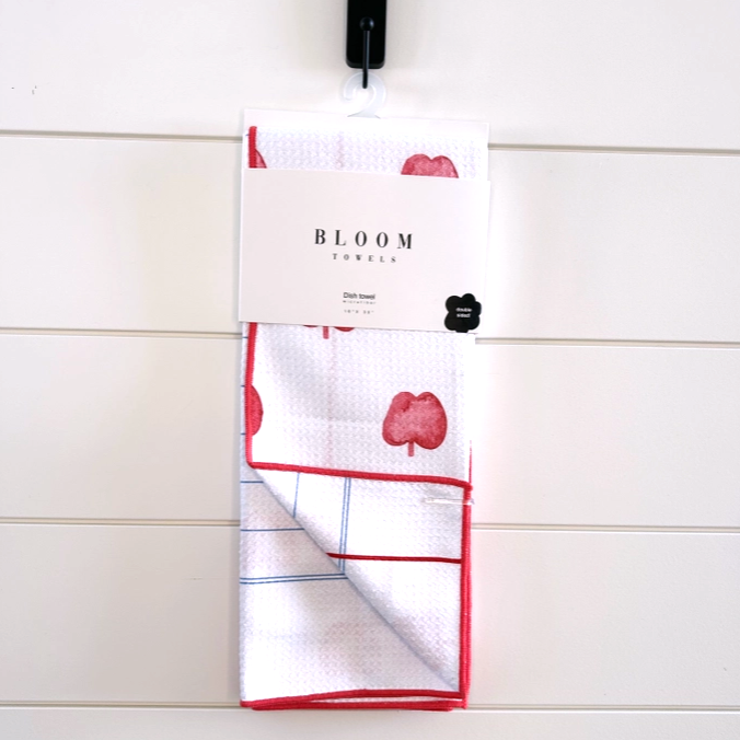 Packaged towel with red apple design on a white background