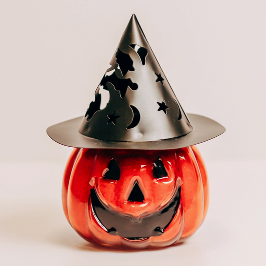 Jack-o'-lantern candle with carved pumpkin face design