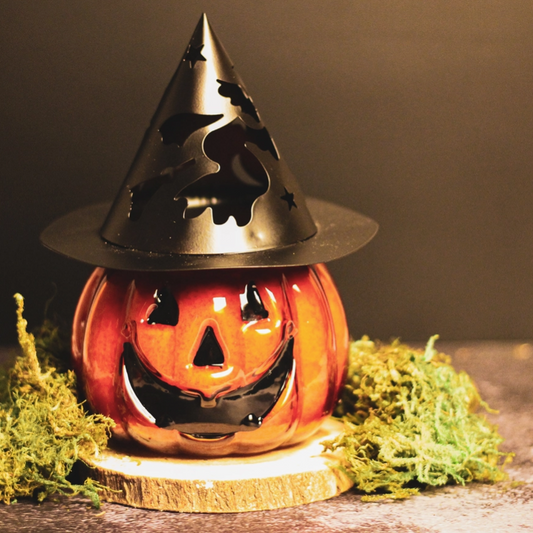Halloween pumpkin-themed candle for spooky ambiance

