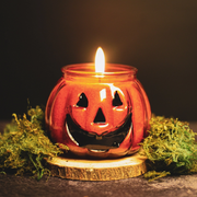 Festive autumn candle featuring classic jack-o'-lantern look