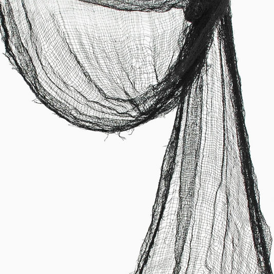 Black creepy cloth draped across a mantle
