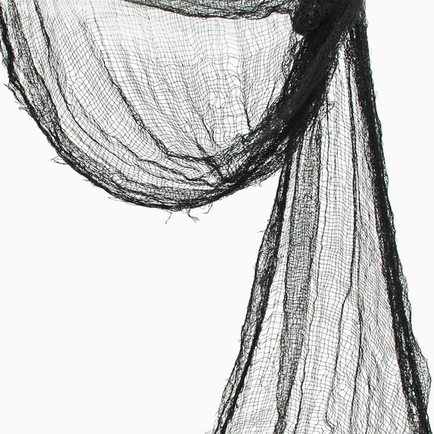 Black creepy cloth draped across a mantle