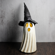 Whimsical Halloween art of a ghost wearing a glowing witch hat