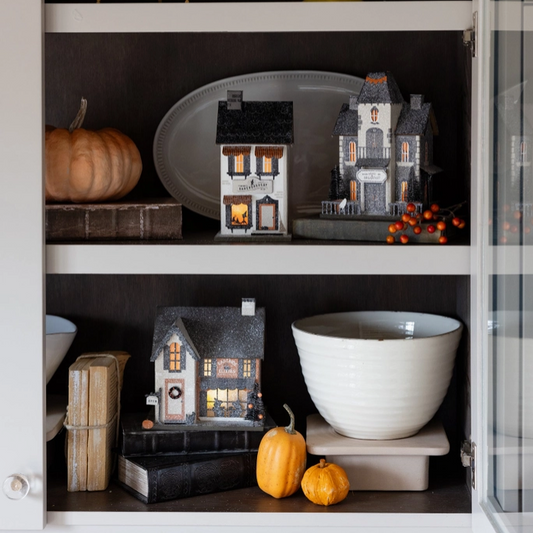 Spooky apothecary-themed wall art featuring a Halloween house illustration