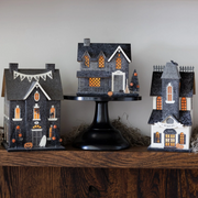 Vintage-style haunted house artwork for Halloween decor