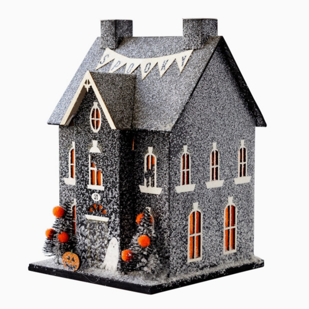 Spooky wall art labeled “Haunted Home” for seasonal decorating