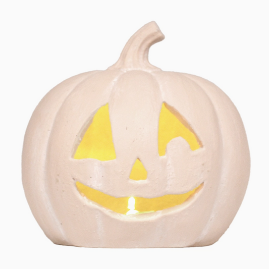 Jack-o'-lantern with carved spooky face lit from inside
