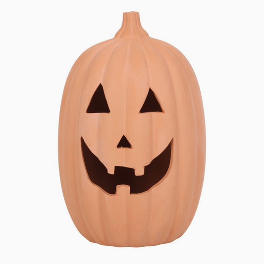 Pumpkin-shaped container with a carved face on a white background