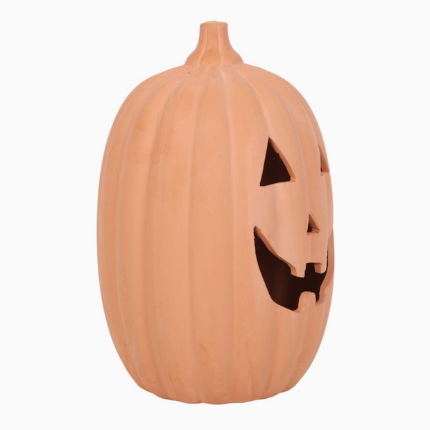 Pumpkin-shaped container with a carved face on a white background
