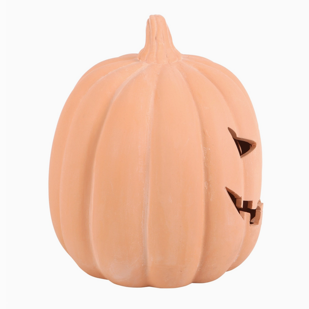 Pumpkin-shaped night light with a triangular face on a white background