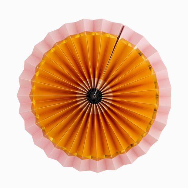 Top view of a decorative umbrella with pink rim and yellow center on a white background
