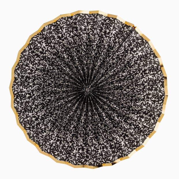 Black and white patterned umbrella with wooden handle on a white background