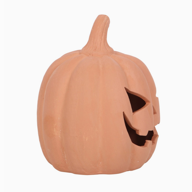Pumpkin with a carved face on a white background