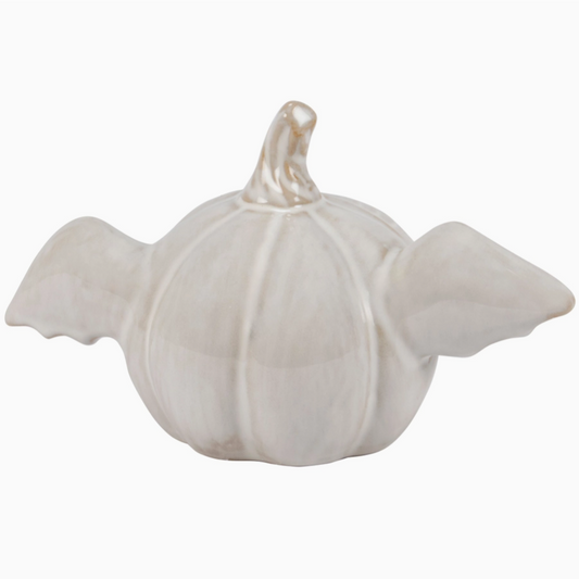 Glowing pumpkin bat decor lit up in dark room