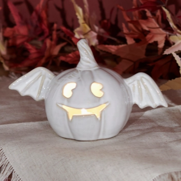 Jack-o'-lantern bat lighting up a haunted scene
