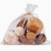 Bag of bath bombs in various colors on a white background