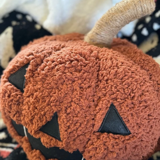 Jack-o'-lantern throw pillow on a couch