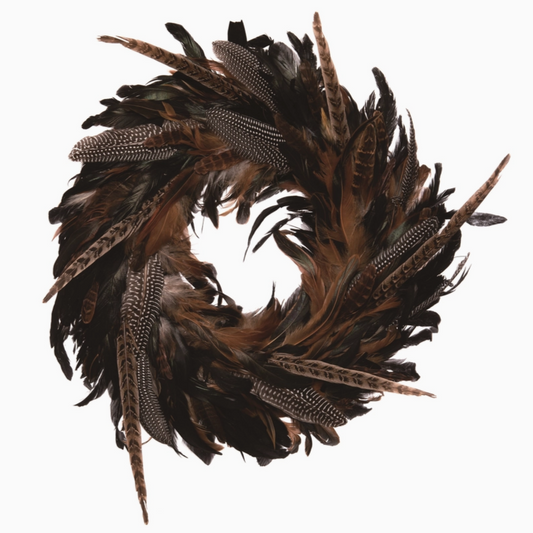 Natural pheasant feather wreath on wall, rustic autumn décor